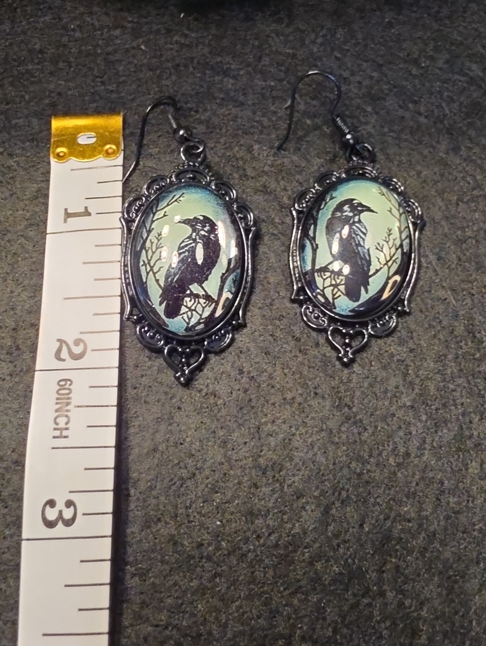 Black Raven Cameo Dangle Earrings in Teal Background